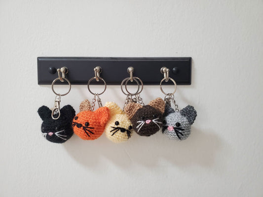 cat keychains hanging from wall